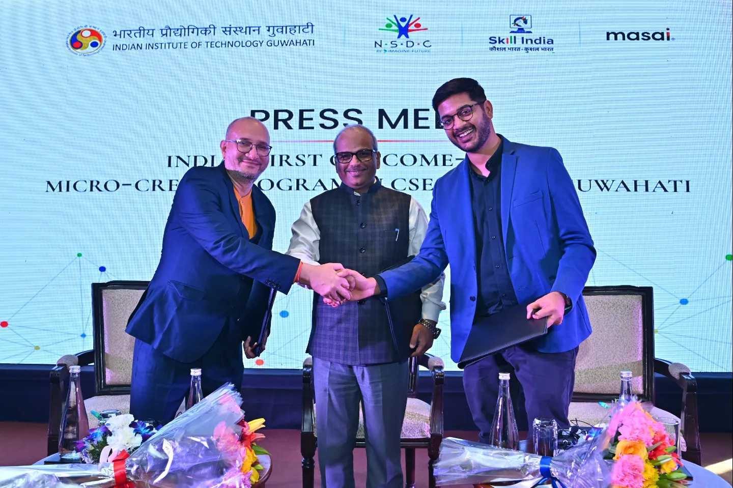 Handshake between three leaders at a press meet announcing the IIT Guwahati partnership