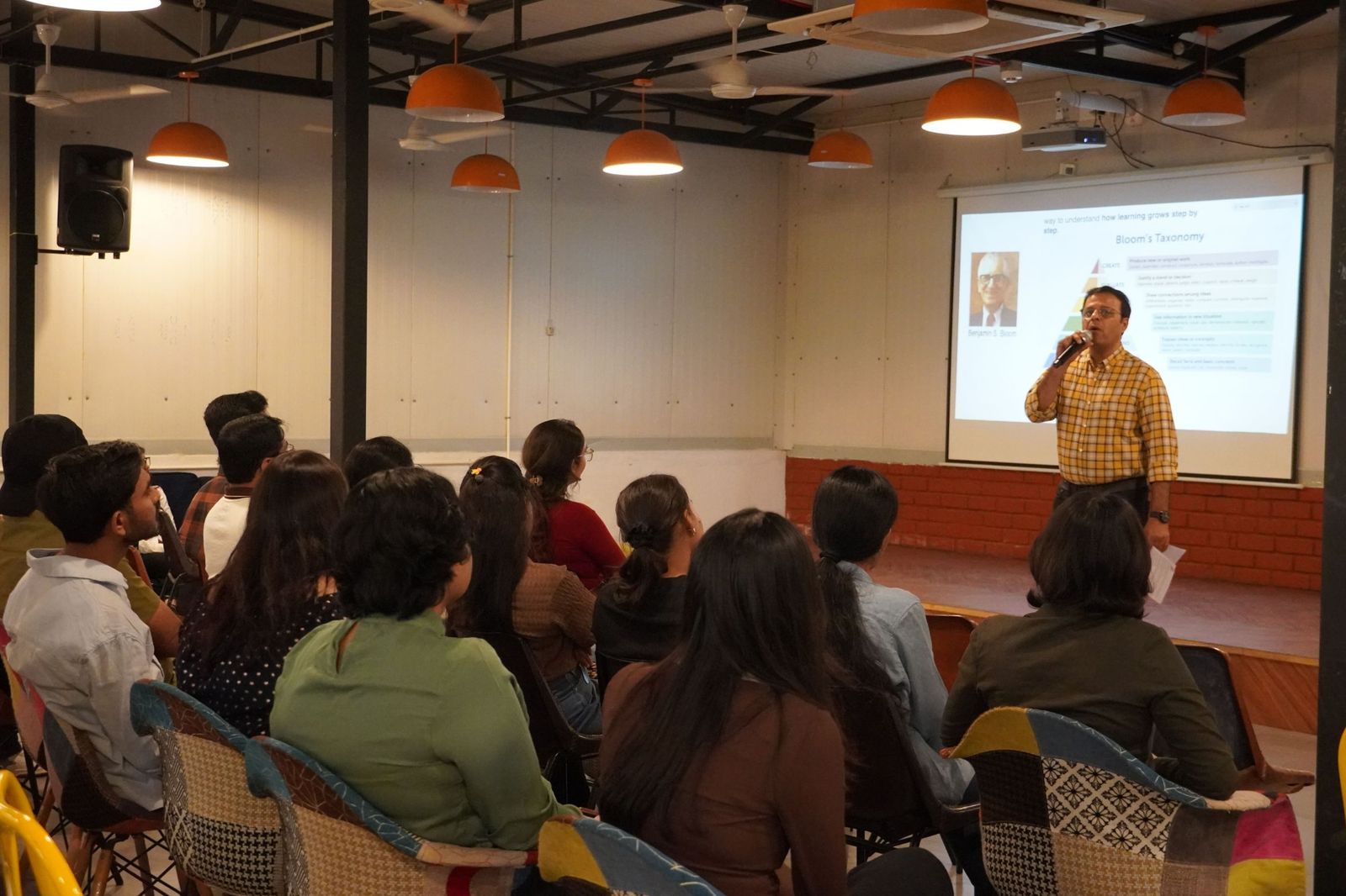 An industry mentor presenting to a seated audience of learners