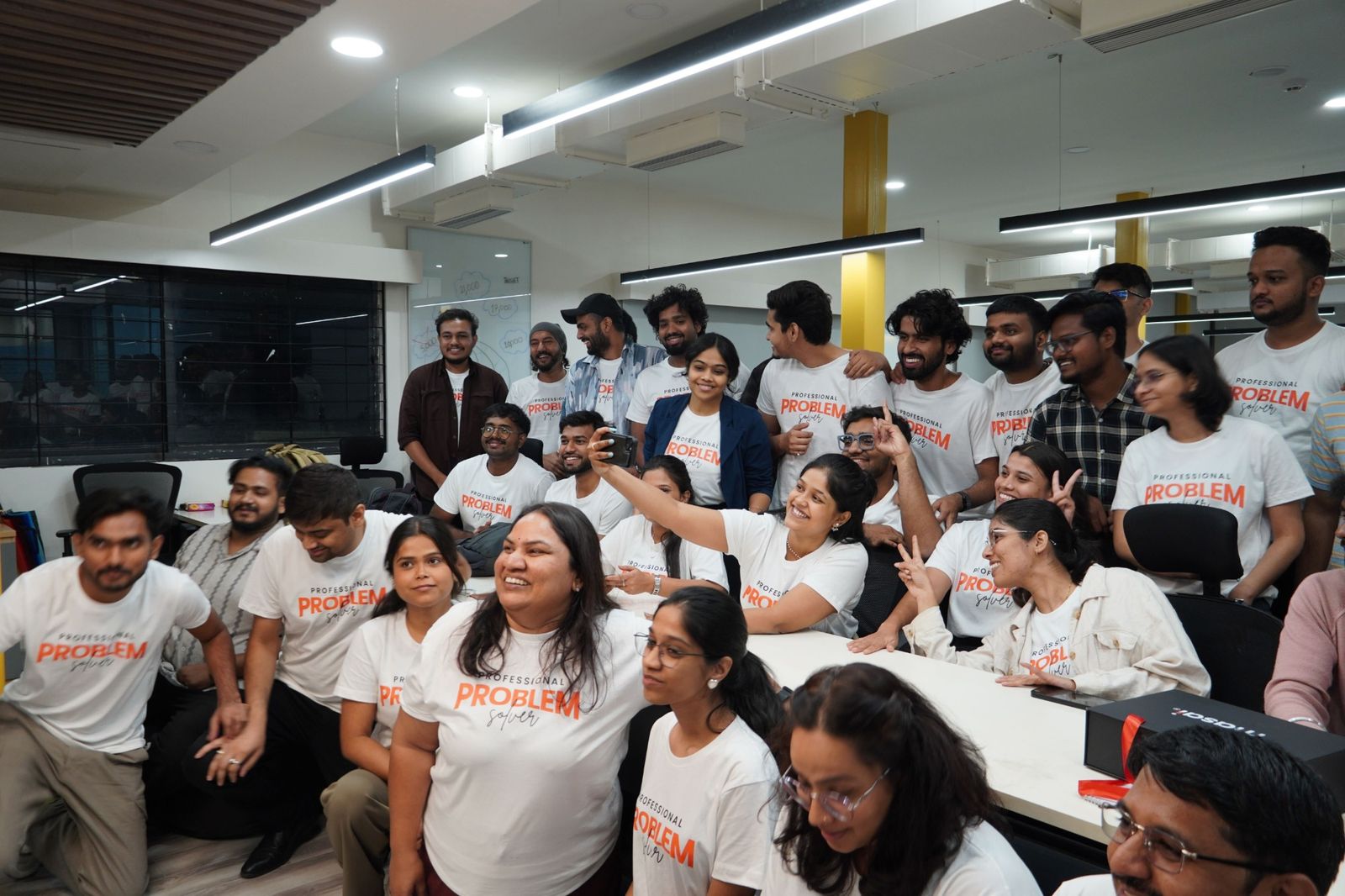Learners in matching Professional Problem Solver t-shirts, smiling